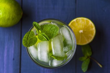Glass of lemonade with lemon and lime slices