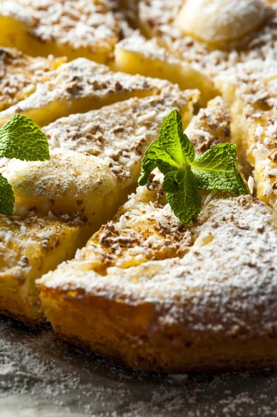 Pieces of pineapple pie with mint on baking paper — Stok fotoğraf