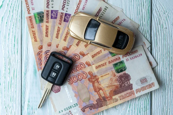 Toy car, banknotes and car key