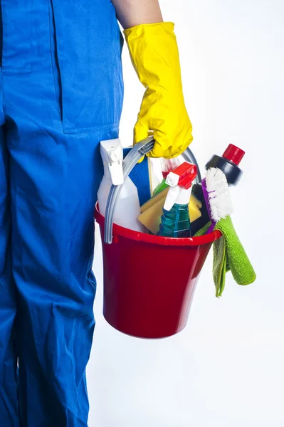 Woman holds a bucket of supplies for cleaning. Isolated on white background. — Stock Photo, Image