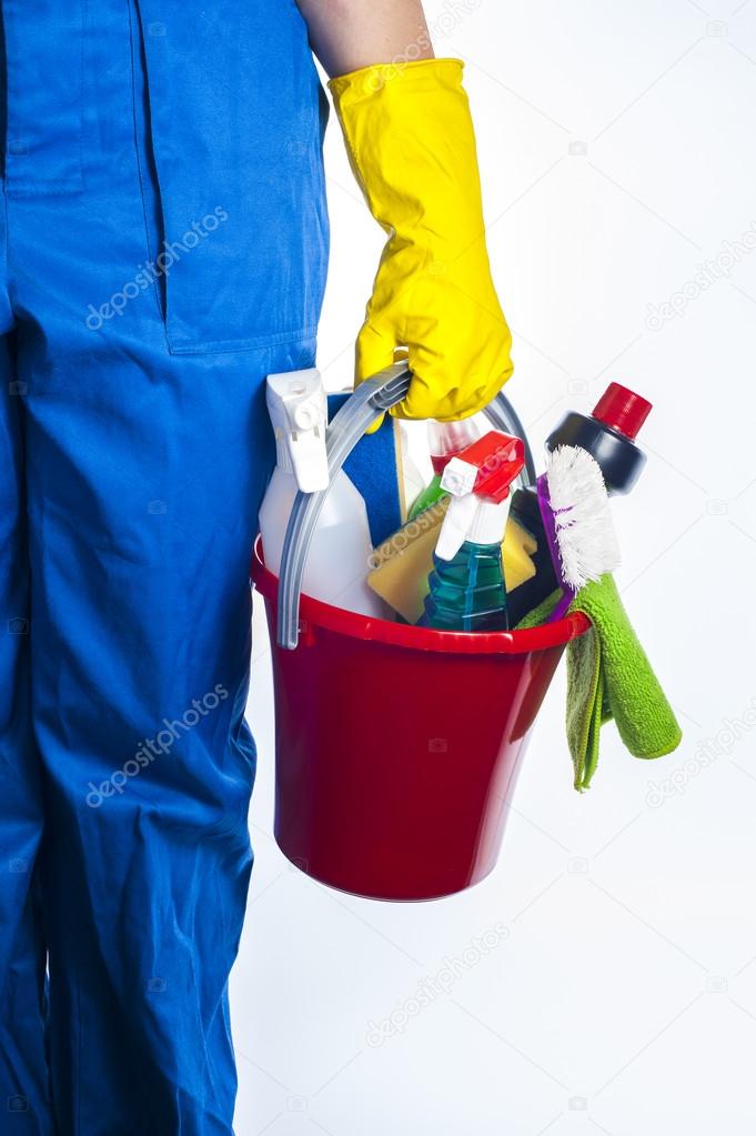 Woman holds a bucket of supplies for cleaning. Isolated on white background.