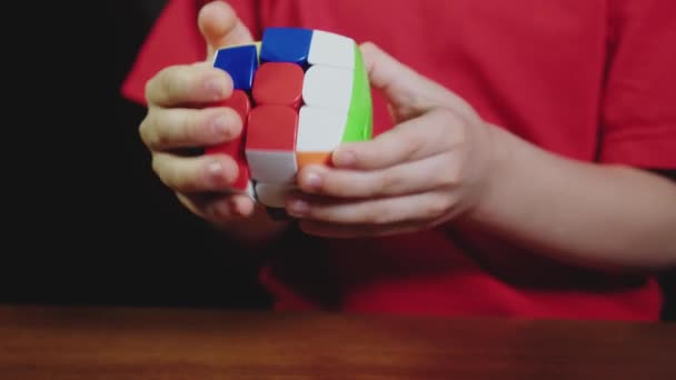 Chłopcy ręce rozwiązywanie rubiks puzzle kostka — Wideo stockowe