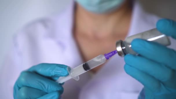 Doctor preparing covid-19 vaccine dose for vaccination. closeup of syringe an — Stock Video