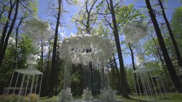 Hochzeitsbogen aus weißen Blumen im Park — Stockvideo