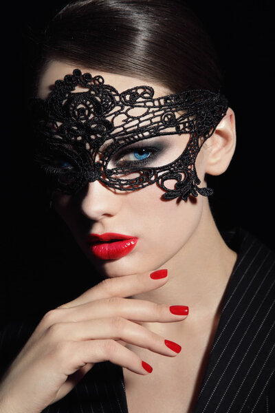 Portrait of young beautiful stylish woman in black lacy mask