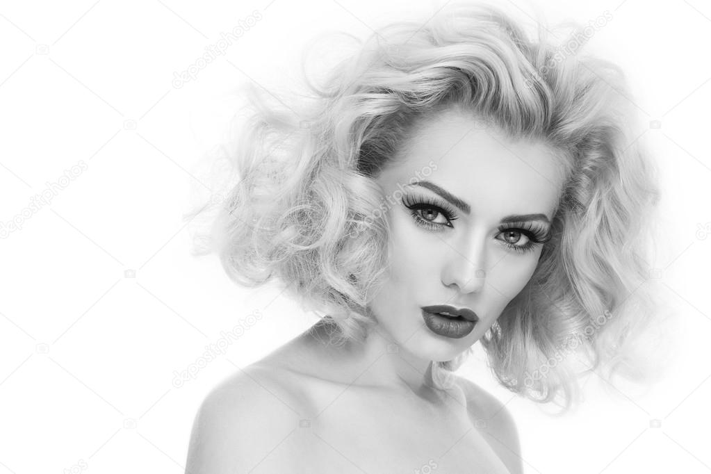 woman with curly hair and false eyelashes