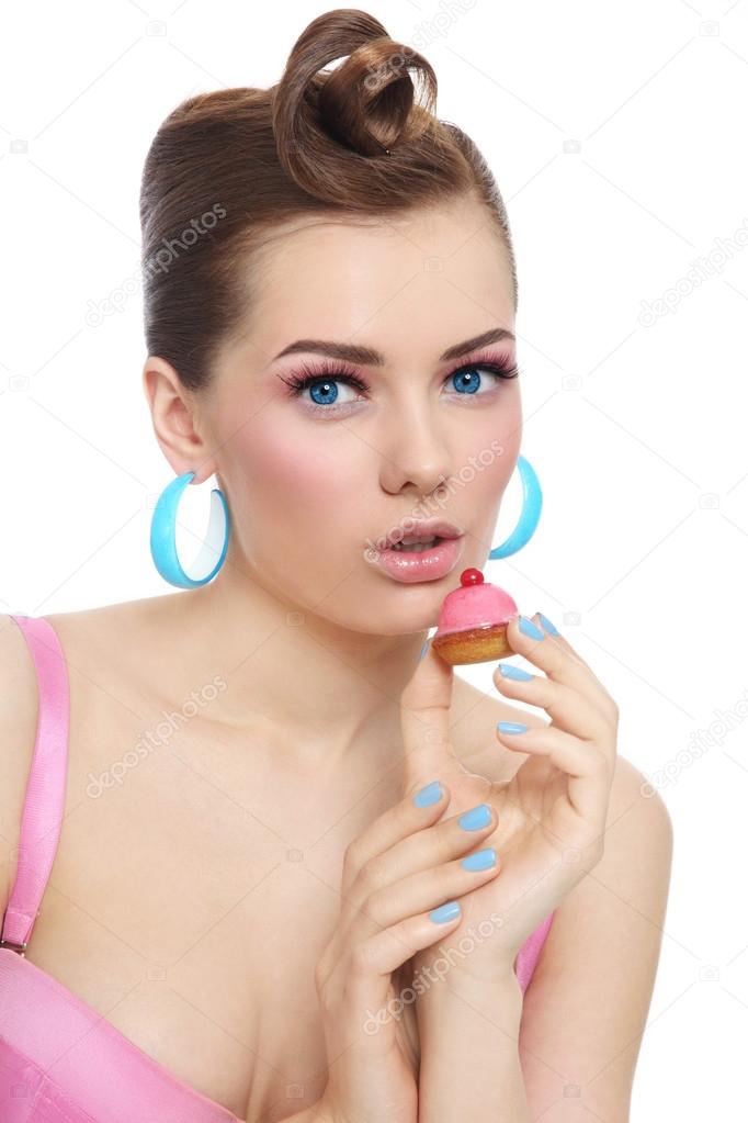 woman with small pastry in hand