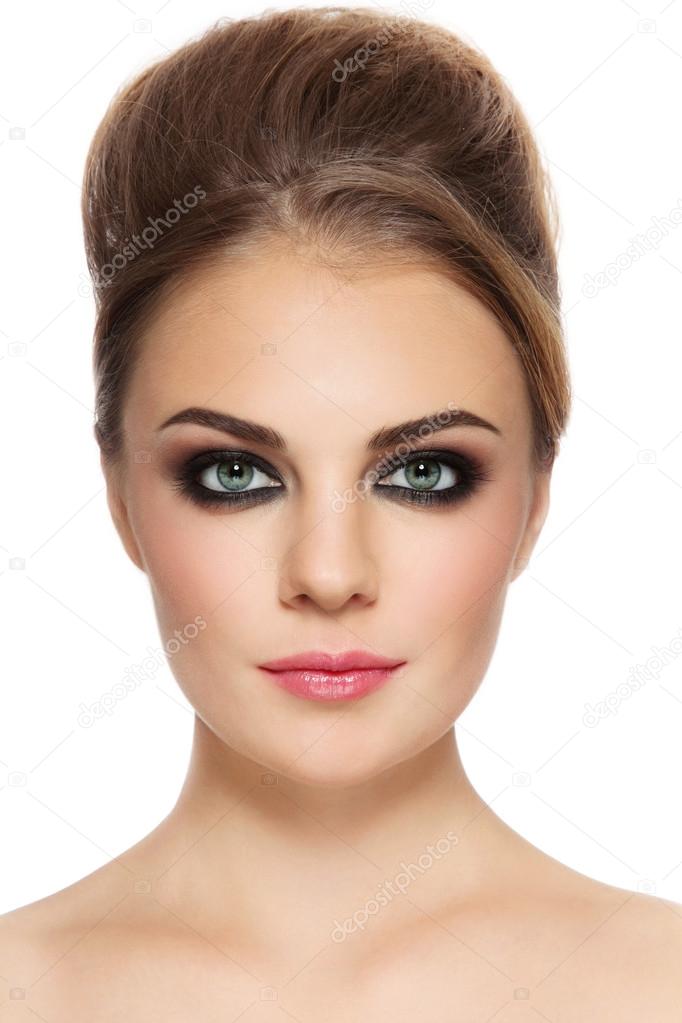 woman with smoky eyes and hair bun