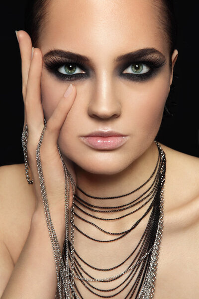 Portrait of young beautiful woman with smoky eyes and extended eyelashes