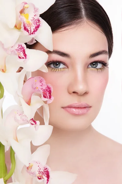 Mulher bonita com orquídeas brancas — Fotografia de Stock