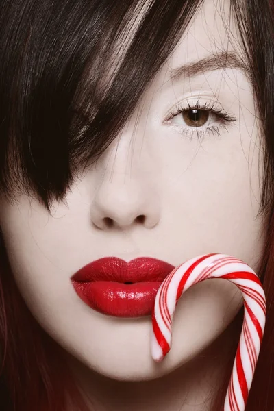 Female face with full lips and candy cane — Stock Photo, Image