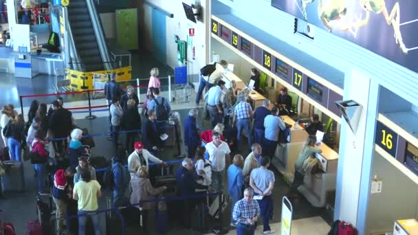 Airline passengers checking in at an Airline Counter — Stock Video