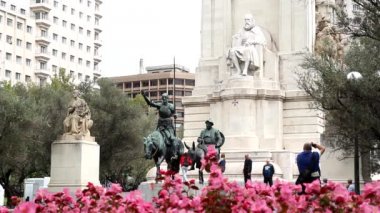Tourist visiting the famous Don Quixote and Sancho Panza statue in Madrid, Spain.