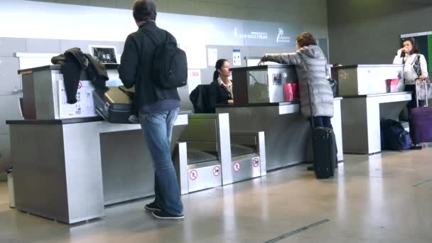 Airline Passengers Checking in at the Counter — Stock Video