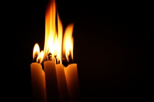 Candles burn in darkness — Stock Video