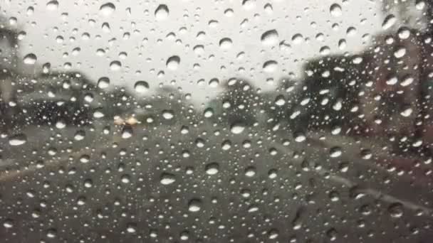 Raindrops on windshield while driving down highway — Stock Video