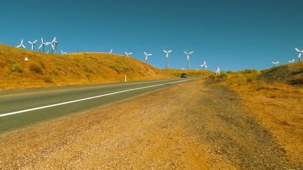 Cars pass Wind Farm in California — Stockvideo