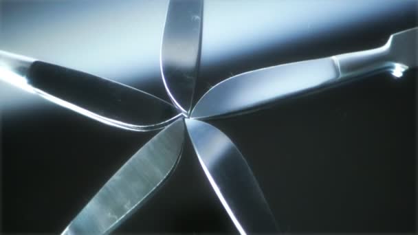 Five Scalpels fanned out rotating on mirror — Stock video