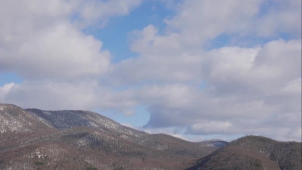 Błękitne niebo białe chmury nad górami śniegu. Puszyste puszyste białe chmury. Cumulus chmura krajobraz timelapse. Czas zimowego błękitnego nieba upływa. Dramatyczne, wspaniałe, błękitne niebo. Miękkie białe chmury tworzą. Czas zachmurzenia — Wideo stockowe