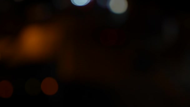 Frumos sclipitor bokeh în fundal întunecat neclar pe timp de noapte. Rotund colorat bokeh strălucește din luminile mașinii de pe strada orașului. În afara focalizării cu înceţoşare. Lumini de oraş nefocalizate. Trafic bokeh. Rezumat — Videoclip de stoc