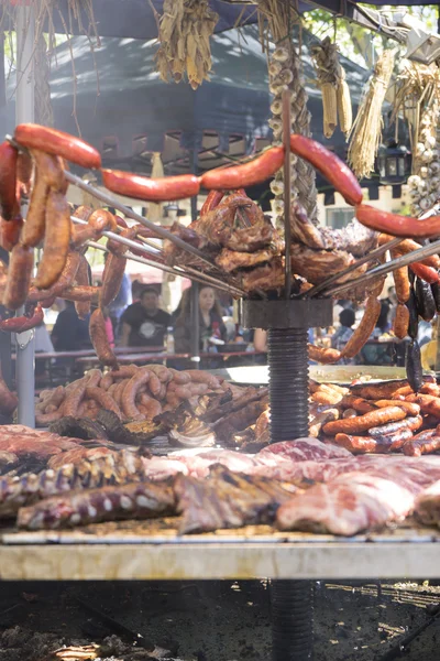 Cook, medieval barbecue with sausages, octopus, meat, ribs and a — Stock Photo, Image