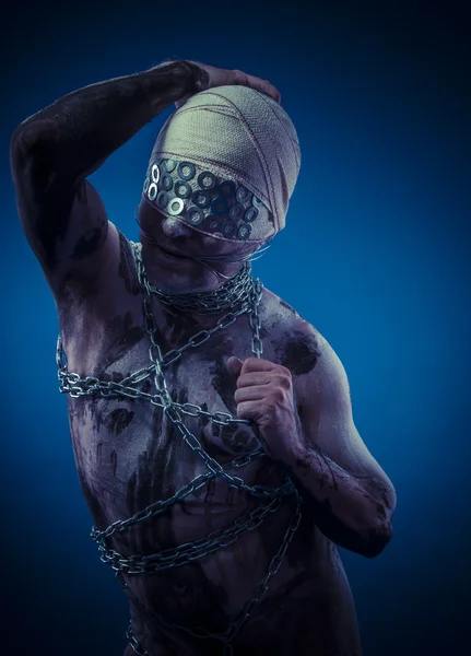 Man with chains and blindfolded