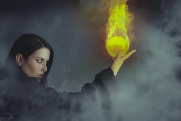 Girl with fire sphere — Stock Photo, Image