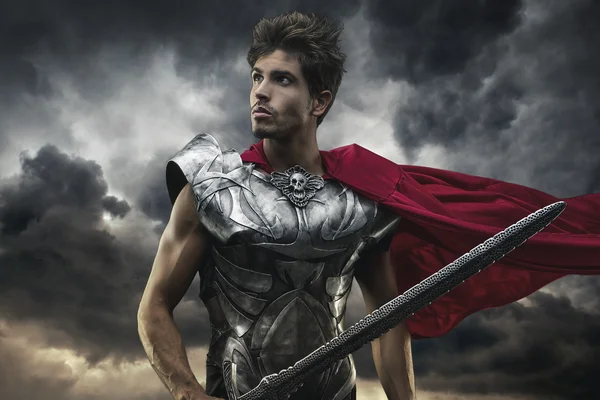 Roman Emperor with red cape and armor looking at the horizon bef — Stock Photo, Image