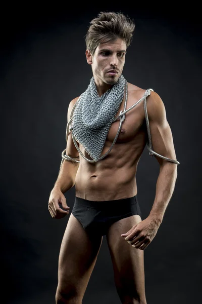 Bodybuilder, attractive naked man with abdominal, chain mesh med — Stock Photo, Image