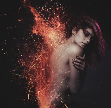 Naked woman surrounded with sparks