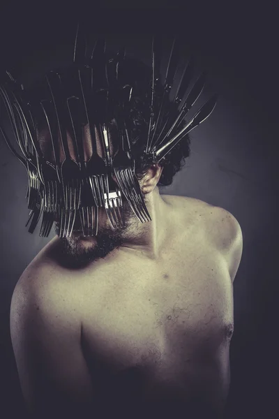 Man with helmet made of forks — Stock Photo, Image