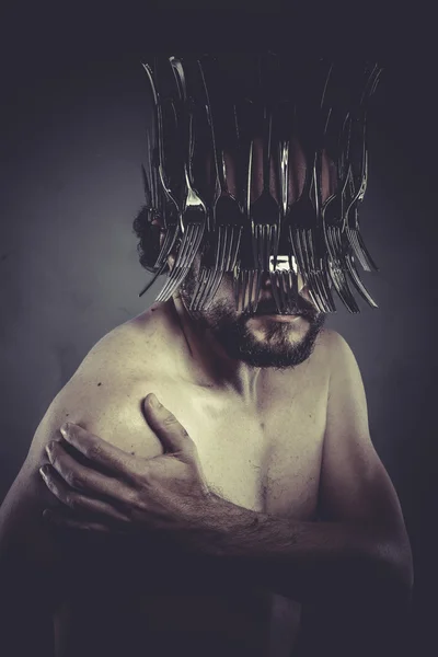 Man with helmet made of forks — Stock Photo, Image