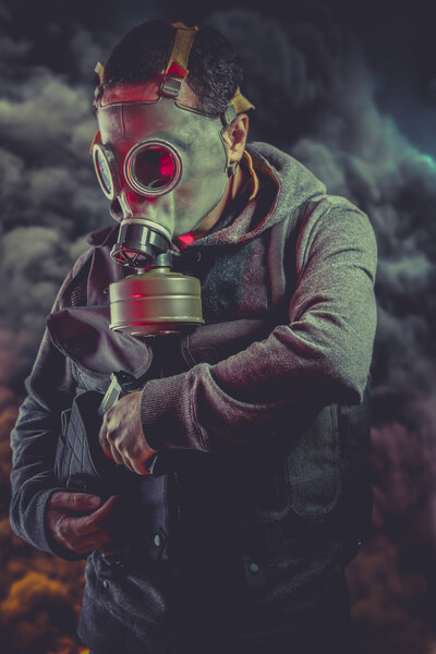 Armed man with gas mask