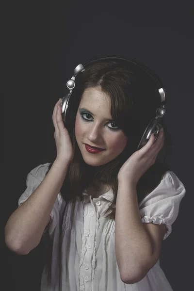 Girl listening music in headphones — Stock Photo, Image