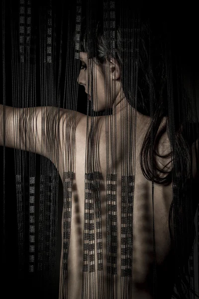 Erotica nude woman back through a curtain wire — Stock Photo, Image