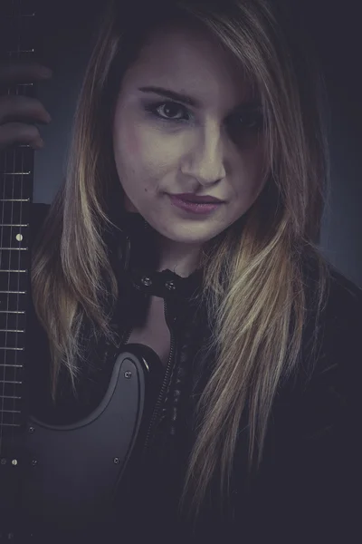 Blonde with black electric guitar — Stock Photo, Image