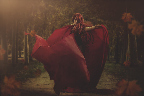 Red hair warrior woman in an autumnal forest