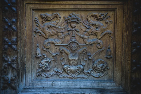 Old wooden door with carvings — Stock Photo, Image