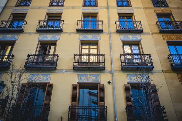 Building with classic balconies on the oldest street in Madrid, Spain