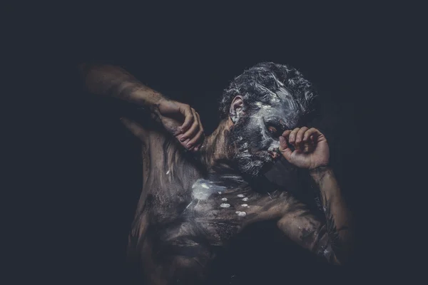 Muscular naked man covered with paint — Stock Photo, Image