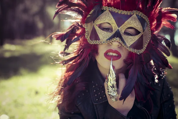 Woman in colorful venetian mask — Stockfoto