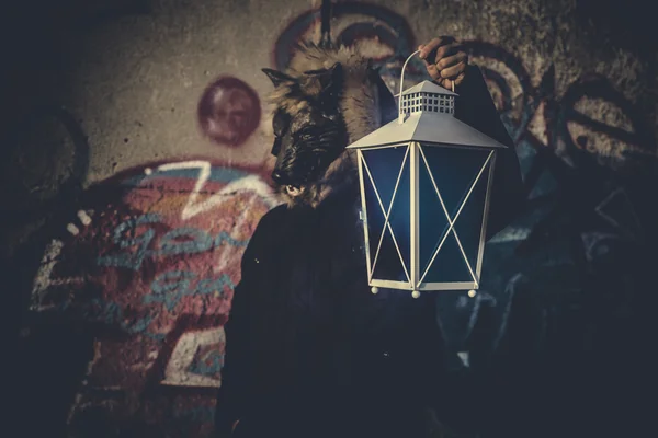 Man with mask wolf and lamp — Stock Photo, Image