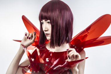 Beautiful, asian woman in abstract clothing