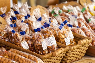 Bags with nuts in baskets on counter