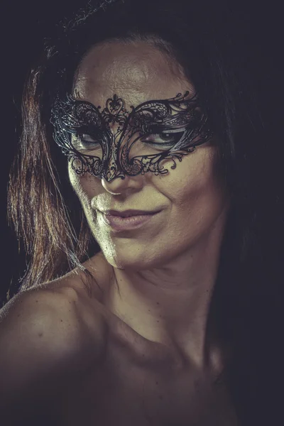 Woman in black venetian mask