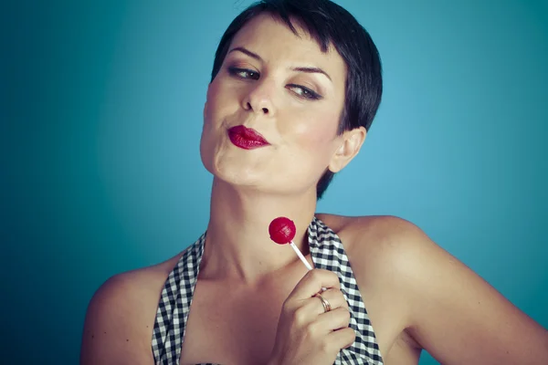 Pretty young woman with lollipop