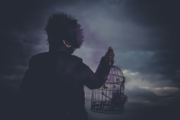 man with mask wolf and lamp with colored smoke