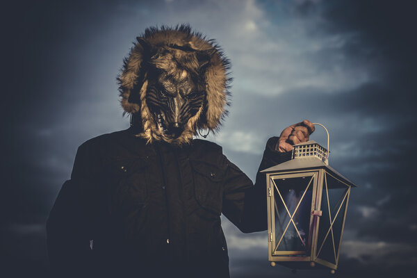 man with mask wolf and lamp with colored smoke