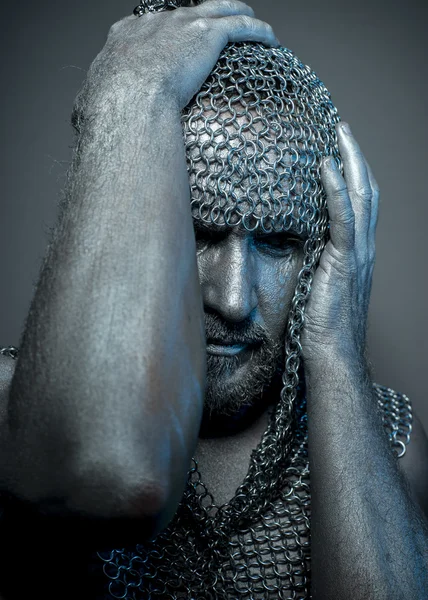 Medieval executioner in mesh iron rings on the head — Stock Photo, Image