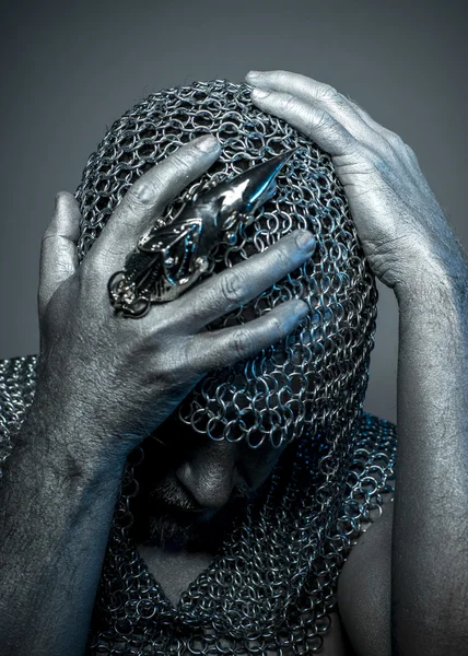 Medieval executioner in mesh iron rings on the head — Stock Photo, Image
